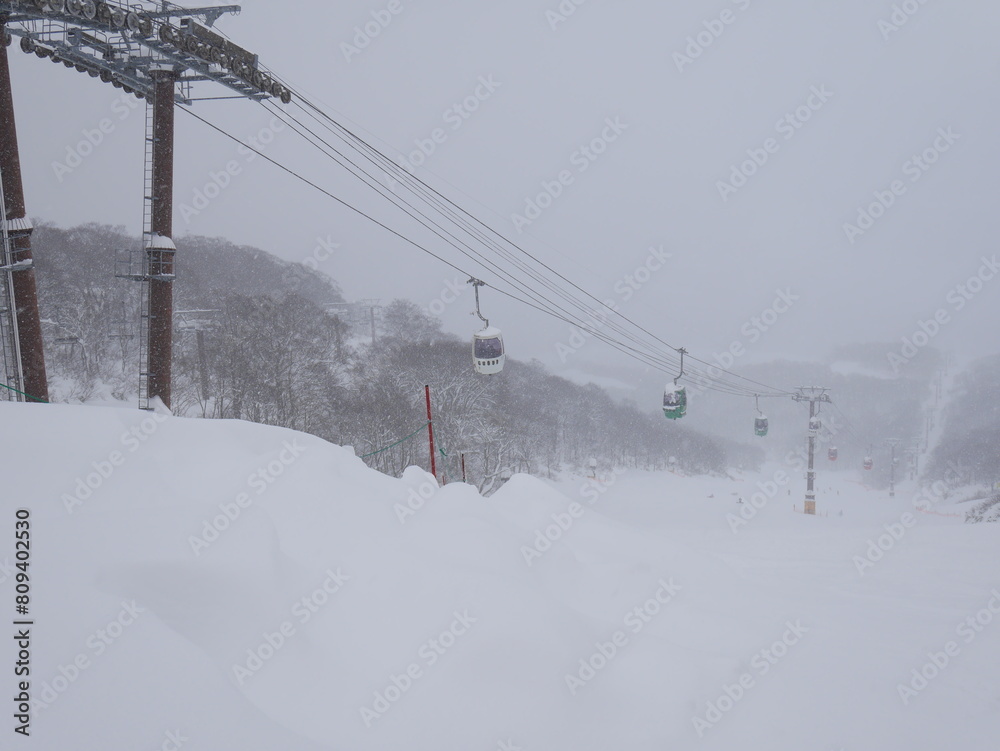 Ski lift cabin with people in the snowfall in mountains Ski lift cabin with people in the snowfall in mountains