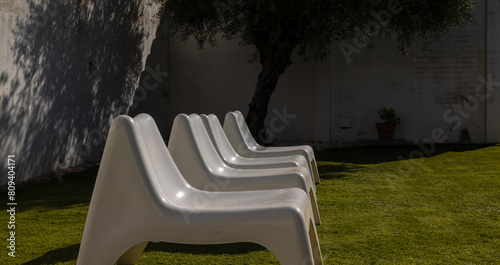 White outdoor chairs on lawn