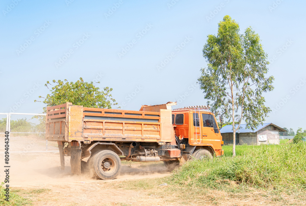Dump truck carrying soil moving on road. Dump truck carrying soil moving on road.