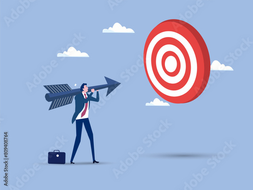 Business man worker holding an arrow precisely aiming at target bullseye achievement for win business strategy or setting goal and target concept © Goodtime
