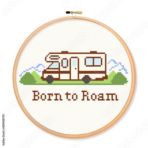 Cross stitch embroidery, recreational vehicle motor home on the road in landscape with Born to Roam text, wooden embroidery hoop, isolated on white background.  