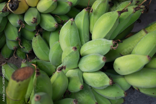 Bunch of ripe green bananas on the market. Selective focus.