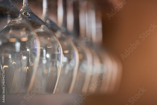 Hanging wine glasses in a row, blurred background