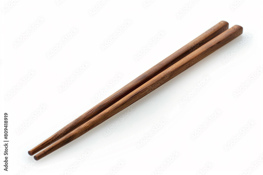 two chopsticks are sitting on a white surface two chopsticks are sitting on a white surface