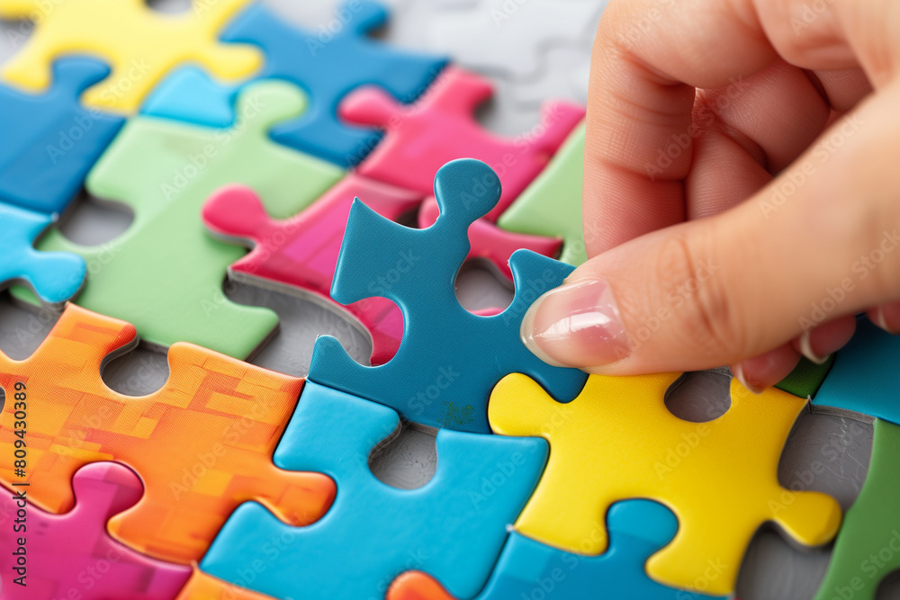 Hands join puzzle pieces, putting the jigsaws team together Hands join puzzle pieces, putting the jigsaws team together