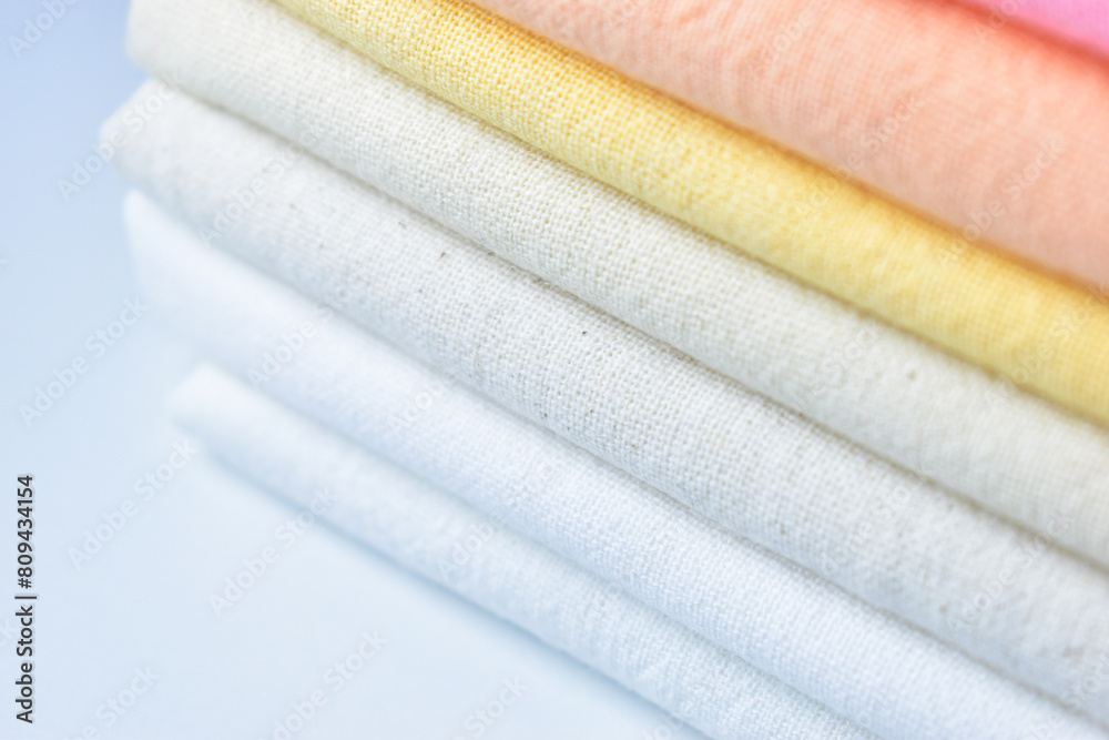 stack of colourful cotton clothes, close up pile of clothing stack of colourful cotton clothes, close up pile of clothing