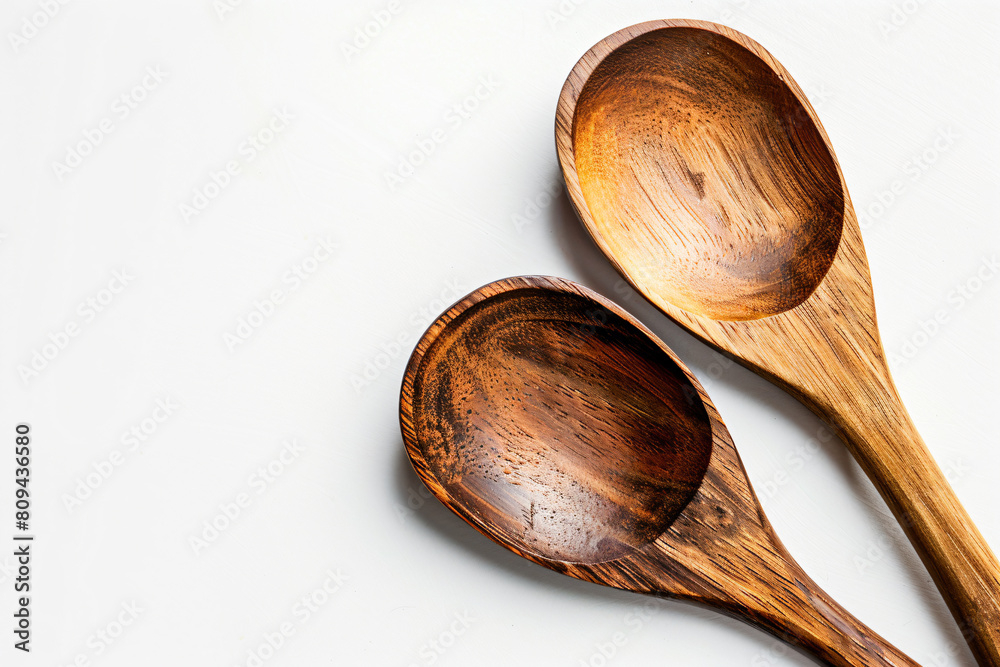 two wooden spoons sitting next to each other two wooden spoons sitting next to each other