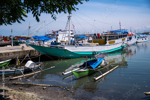 Traditional wooden boats anchor at Paotere Traditional Harbor in Makassar  Indonesia. Paotere Harbor is one of the legacies of the Gowa Tallo Kingdom  which is located in the northern part of Makassar