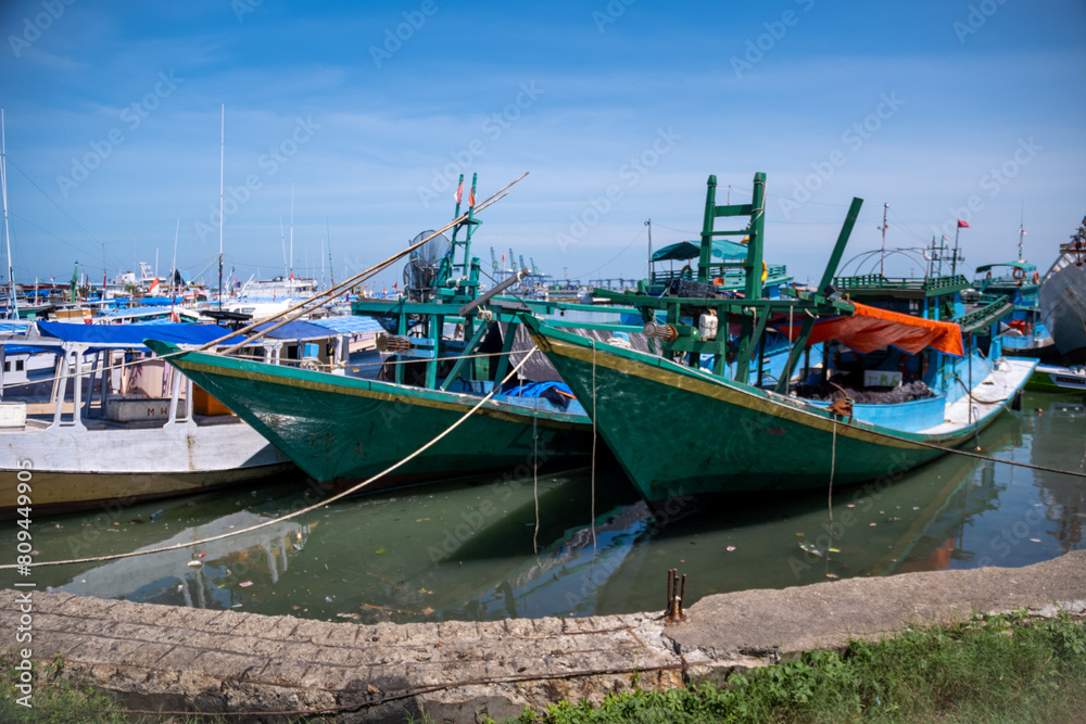 Traditional wooden boats anchor at Paotere Traditional Harbor in Makassar, Indonesia