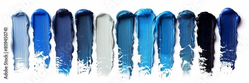 A set of blue color paint strokes isolated on a white background, viewed from the top, serving as blue shades swatches for makeup, cosmetic product, or beauty industry concept.