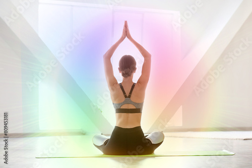 Young woman practicing yoga...