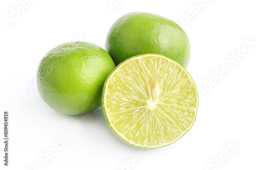 Natural fresh lime and lime cut in half. Fresh ripe green limes on a white background.