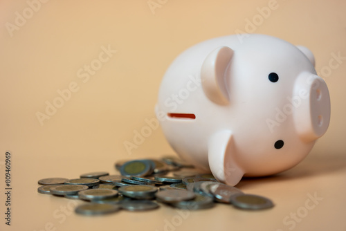 Financial problem, Bankrupt or fail in business concept. Pink piggy bank in falling position and coin stack. Fail, bankrupt or unsuccessful idea.