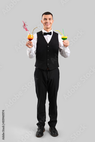 Young male bartender with g...