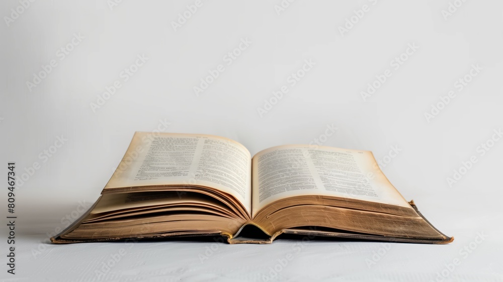 Aged open book with turning pages, capturing the concept of time and history on a pure white background Aged open book with turning pages, capturing the concept of time and history on a pure white background