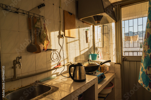 A slanted side-view of a semi-open rusty kitchen inside the photographer's home (Submitted on his own will)