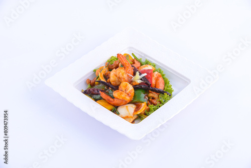 Sweet and sour shimp stir fried on the white dish.