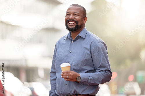 Mature man, coffee and walking by city street with lens flare, travel and commute on urban road. Happy black male entrepreneur, drink and smile for outdoor trip with work break, downtown and sunshine photo