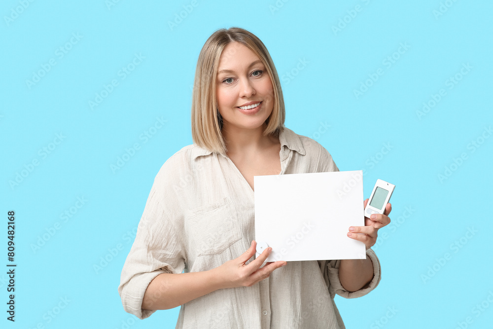 Woman with glucometer, sensor for measuring blood sugar level and blank paper on blue background. Diabetes concept Woman with glucometer, sensor for measuring blood sugar level and blank paper on blue background. Diabetes concept