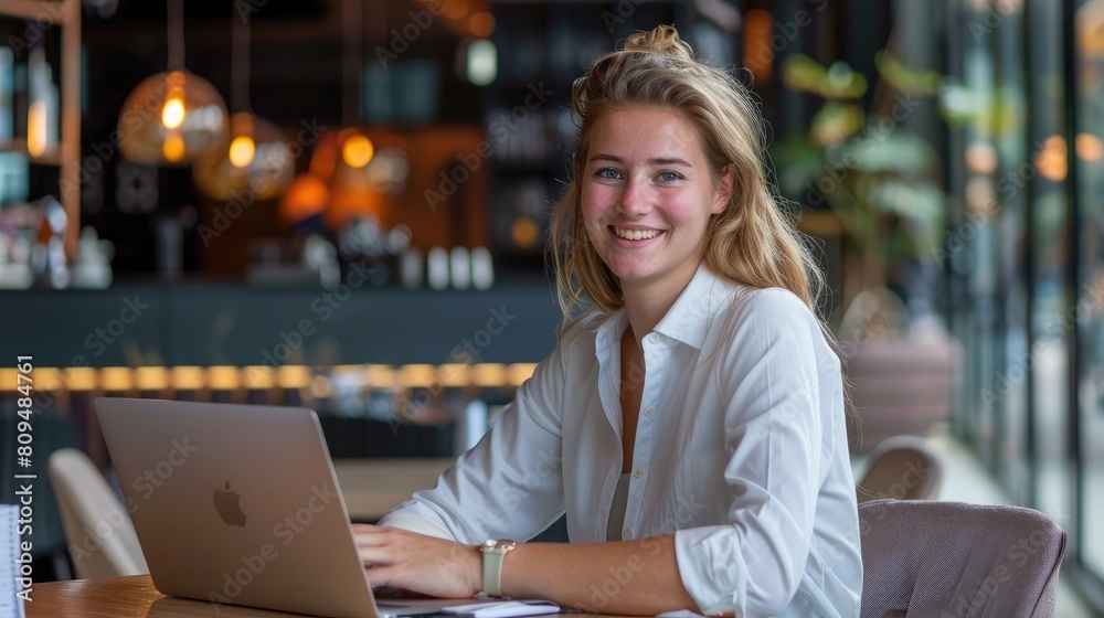 portrait of beautiful young businesswoman working on a laptop in restaurant