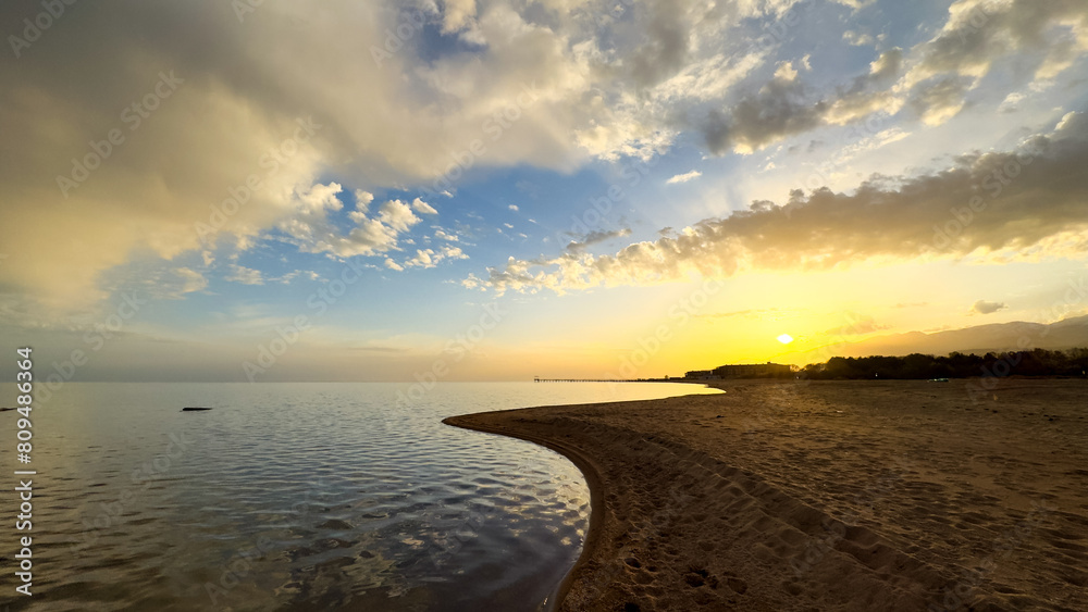 Beautiful sunset on the lake. Mountains and water. Kyrgyzstan, Lake Issyk-Kul