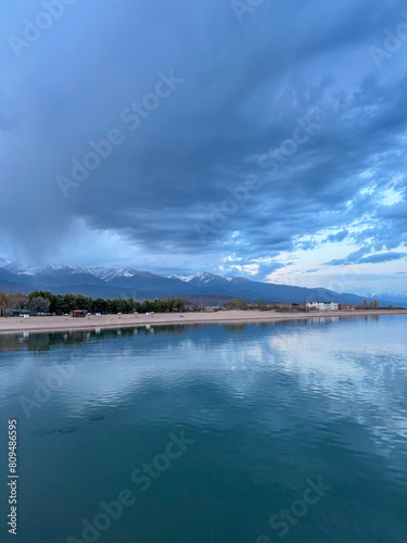 Sunny summer day on the lake. Mountains and sea. Kyrgyzstan  Lake Issyk-Kul