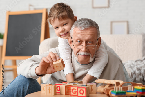 Happy grandfather playing w...