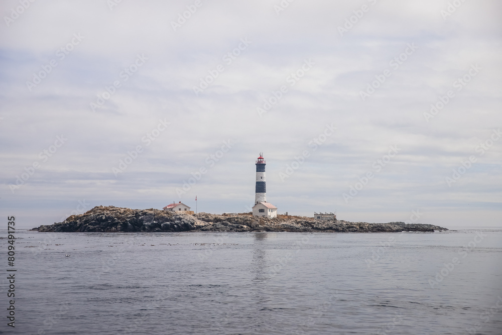 Lighthouse on a small island in the middle of the ocean. Vancouver Island. Island in the Pacific Ocean.