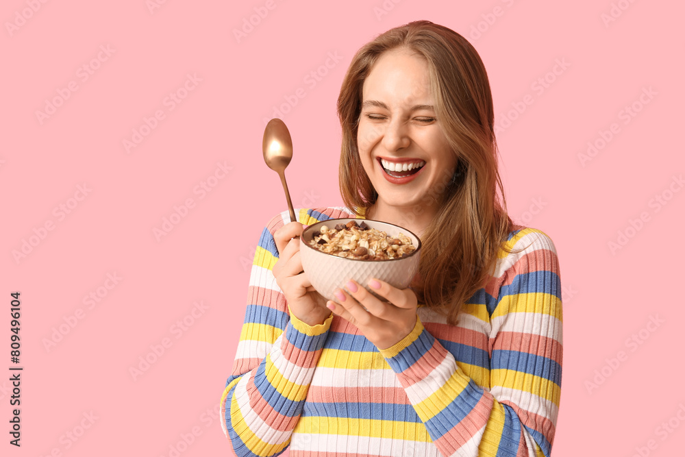 Happy young woman with bowl of healthy oatmeal on pink background Happy young woman with bowl of healthy oatmeal on pink background
