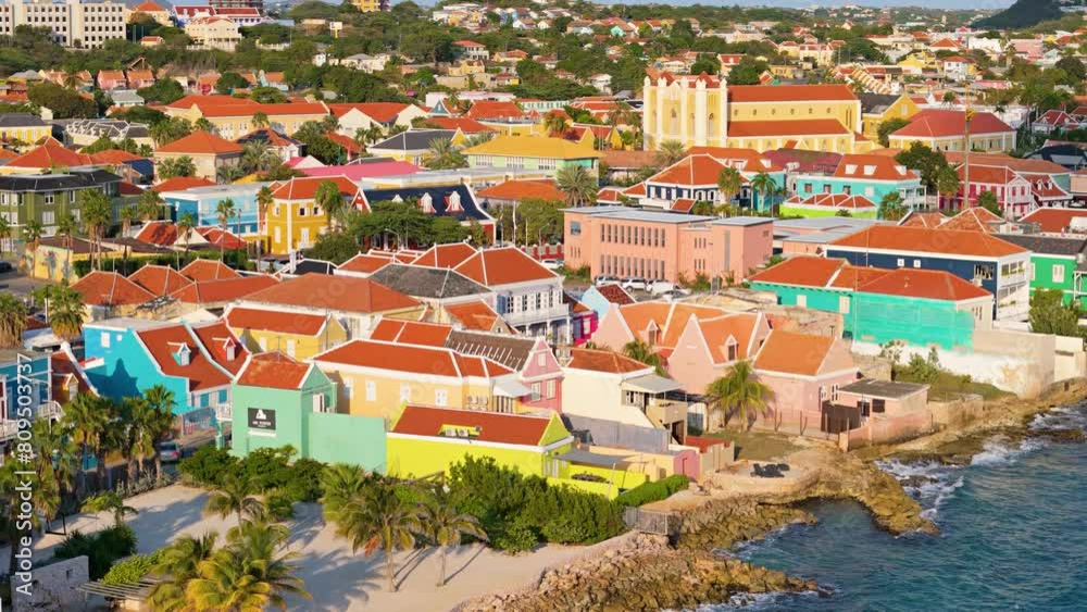 Vibrant yellow orange blue multi colored home buildings in Willemstad Curacao on the coast