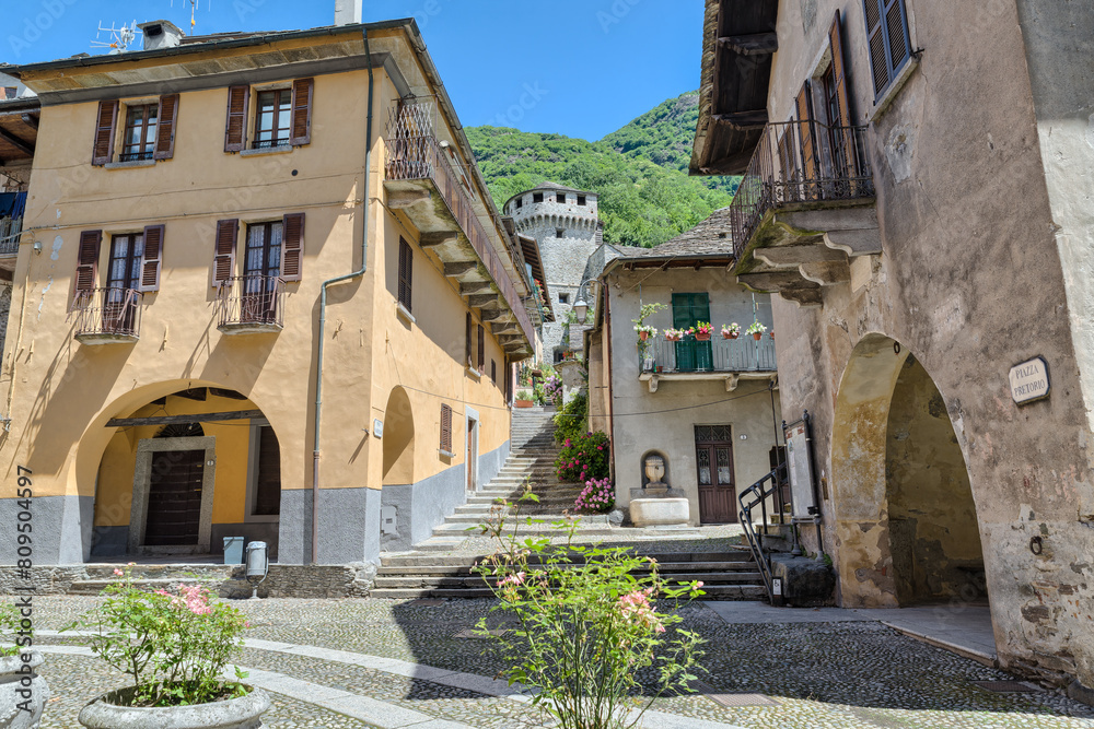 Ancient square with historic buildings. Vogogna town, part of the circuit of the most beautiful villages in Italy, with the Visconteo Castle and the praetorian Palace (palazzo Pretorio), 14th century