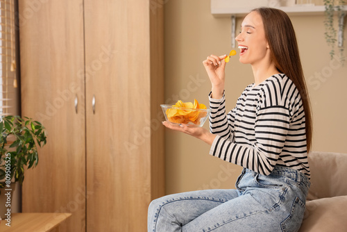 Young woman eating potato c...