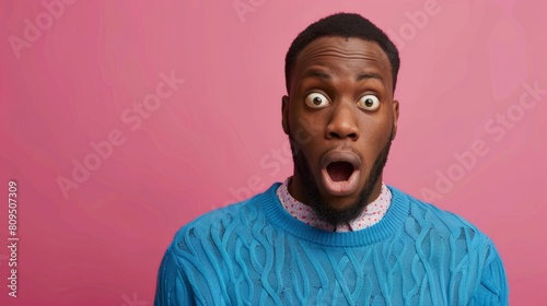puzzled african american man in blue sweater in amazement on pink isolated background, confused and stunned man hyper realistic  photo
