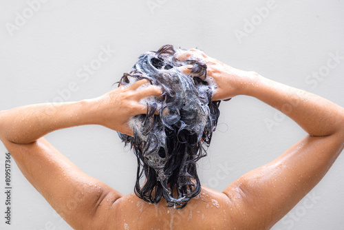 Beautiful woman's hand She was washing her hair and nourishing her scalp. Shampoo and conditioner 