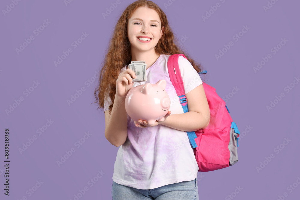 Happy female student with backpack, piggy bank and money on lilac background Happy female student with backpack, piggy bank and money on lilac background