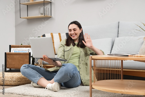 Young woman with laptop vid...