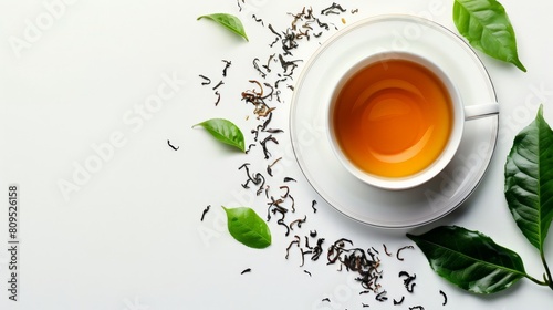 White cup of tea on white background with green tea leaves scattered around. Cup of Tea and Coffee with Mint on Saucer Cup of tea and tea leaves border isolated on white background banner panorama, photo