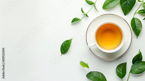 White background with tea leaves and a cup of tea. Cup of Tea and Coffee with Mint on Saucer Cup of tea and tea leaves border isolated on white background banner panorama, top view, flat lay photo