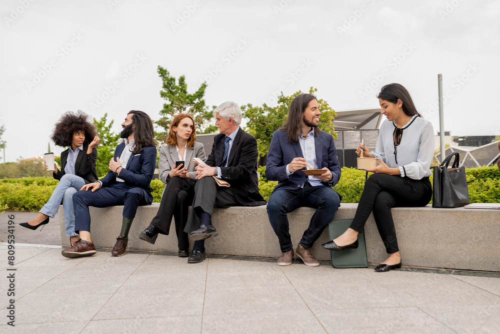 Fototapeta premium Diverse Corporate Team Engaging in Casual Outdoor Meeting