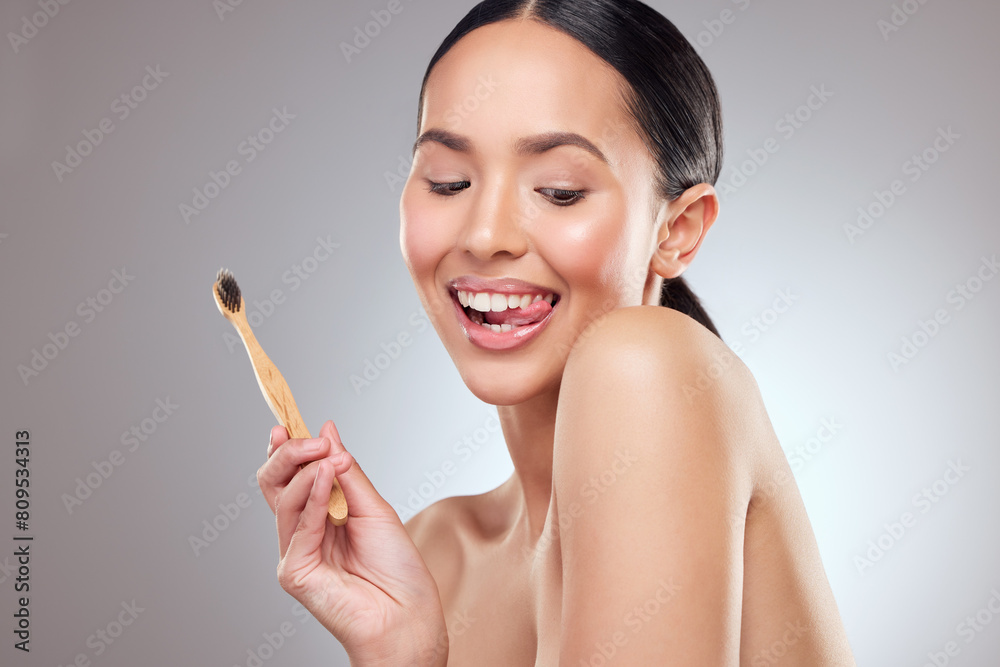 Playful, smile and toothbrush with oral hygiene woman in studio on gray background for dental care. Face, tongue and happy person brushing teeth in bathroom to prevent cavity, decay or gum disease Playful, smile and toothbrush with oral hygiene woman in studio on gray background for dental care. Face, tongue and happy person brushing teeth in bathroom to prevent cavity, decay or gum disease