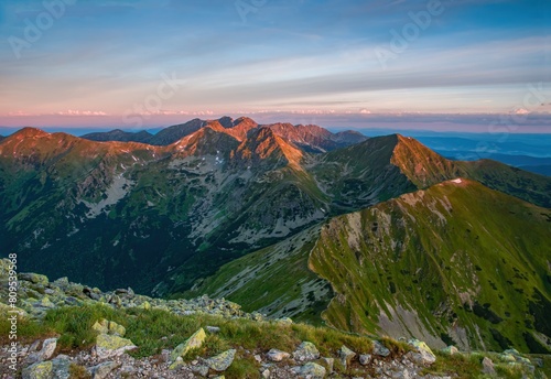 Otrhance mountain ridge near Jakubina peak in Western Tatras mountains in Slovakia with other peaks scenery, hiking trail, relaxing people on stone and blue sky with clouds. Hiking theme.  photo