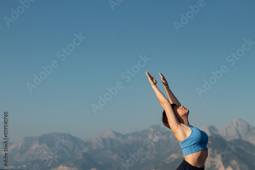 Yoga woman doing yoga pose on the beach for wellbeing health lifestyle. photo