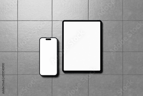 Blank Tablet and Smartphone on cement background