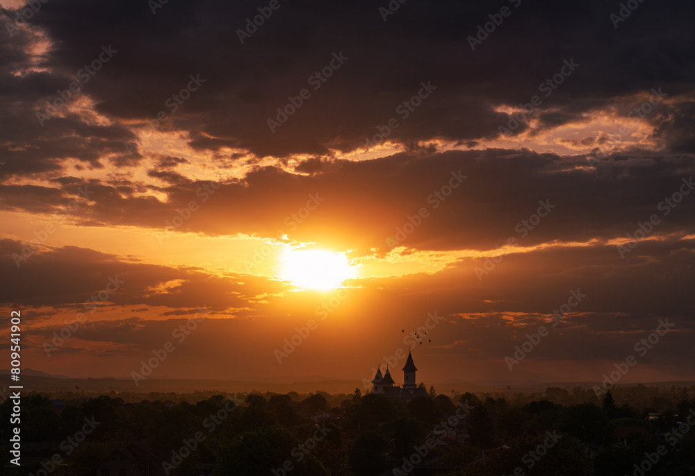 Orthodox church in sunset light. Amazing aerial view during sunset over a landmark orthodox church in Moldova region from Romania. Church and Christian cross silhouette religion. Orthodox church in sunset light. Amazing aerial view during sunset over a landmark orthodox church in Moldova region from Romania. Church and Christian cross silhouette religion.