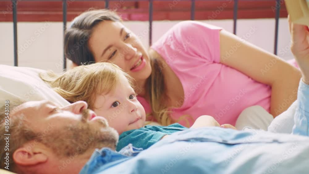 Caucasian parents spend leisure time with baby boy in bedroom at house. Caucasian parents spend leisure time with baby boy in bedroom at house.