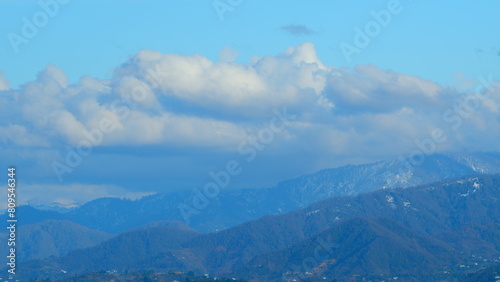 Snowy Hill With Moving Clouds Blown By The Wind. Beautiful Mountain Landscape In Winter.