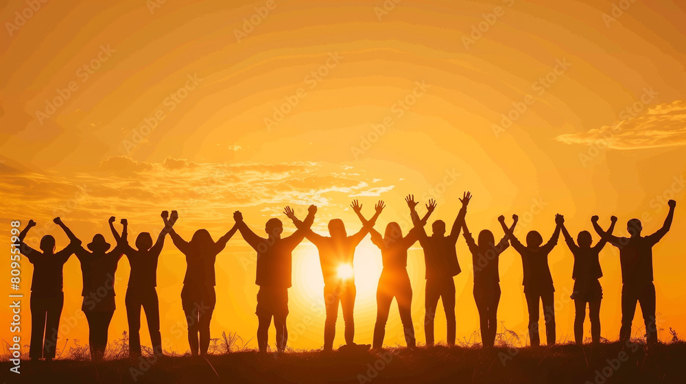 A group of people are holding hands in a field at sunset. Scene is one of unity and togetherness A group of people are holding hands in a field at sunset. Scene is one of unity and togetherness