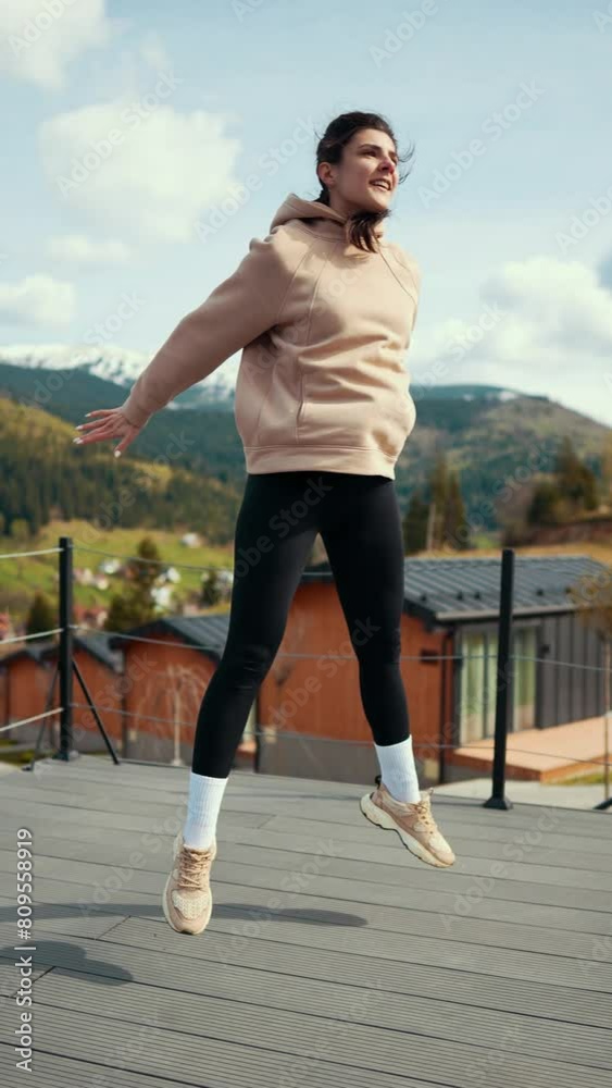 Young woman does morning exercises on the terrace of a hotel overlooking the snow-capped mountains. The concept of a healthy lifestyle. Vertical video Young woman does morning exercises on the terrace of a hotel overlooking the snow-capped mountains. The concept of a healthy lifestyle. Vertical video