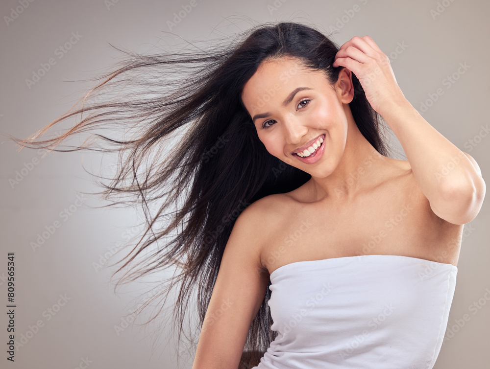Wind, portrait and haircare for woman with smile, healthy and promotion of hair, results and confidence. Studio background, salon treatment and growth for girl, hairstyle and proud of routine in USA Wind, portrait and haircare for woman with smile, healthy and promotion of hair, results and confidence. Studio background, salon treatment and growth for girl, hairstyle and proud of routine in USA