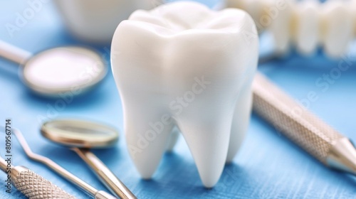 Photography of Dentistry concept. Model of a tooth and dental instruments on a blue background.